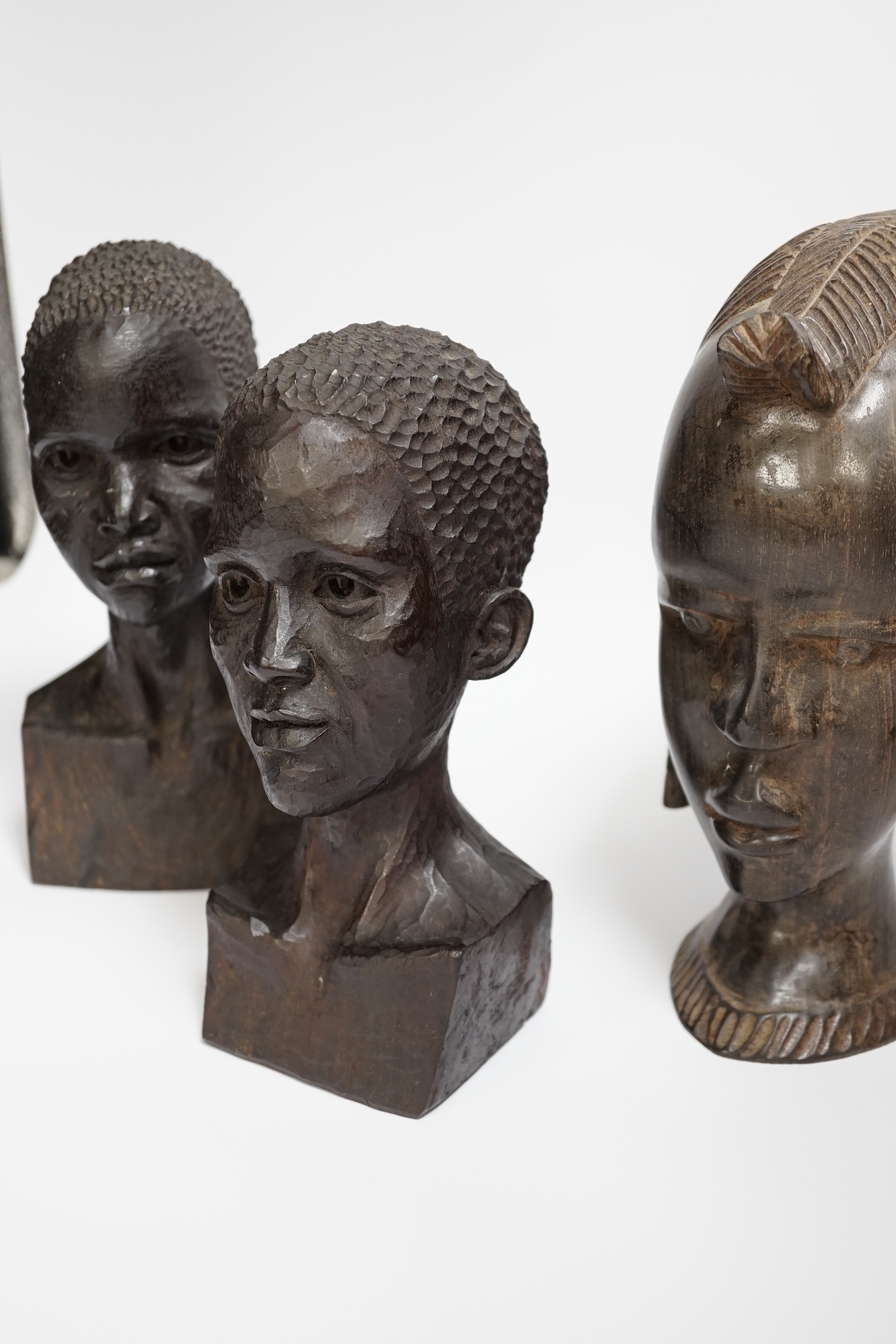 Three carved ebony African busts, tallest 23cm